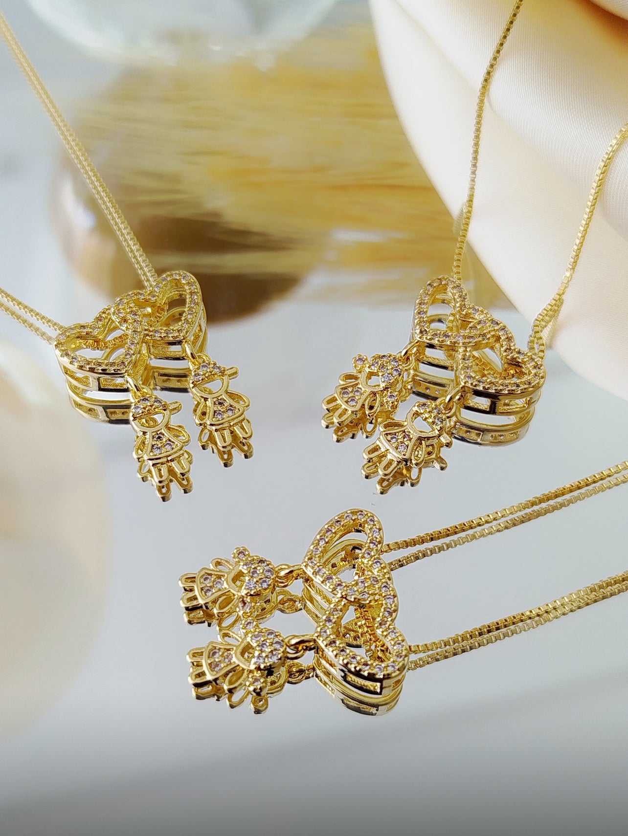 18-inch necklace featuring two sparkling heart pendants adorned with two child charms 12151