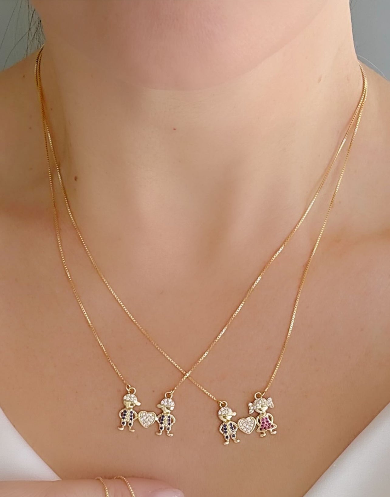 18-inch necklace with two sparkling child charms and a heart pendant 12240