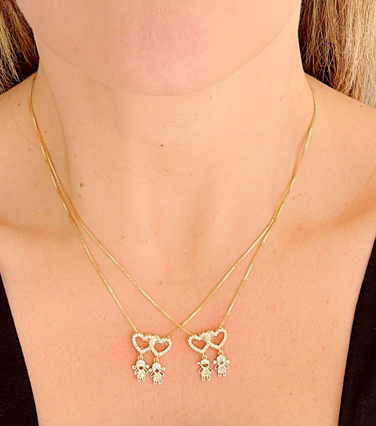 18-inch necklace featuring two sparkling heart pendants adorned with two child charms 12151